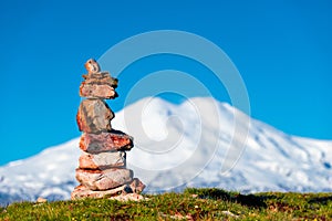 Stone seid on the background of the snow-capped peak of Mount Elbrus high