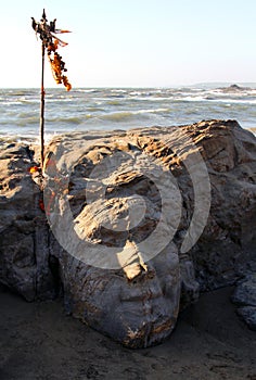 Stone Shiva face on Vagator beach of Goa