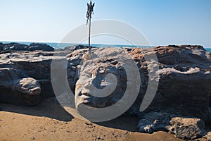 Stone Shiva face on Vagator beach of Goa