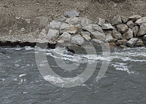 stone shoring on the river bank