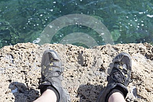 A stone slab near the sea. The texture of the water and stone.