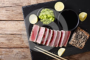 Stone slate tray with sliced tuna steak fried in sesame seeds. T