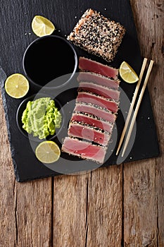 Stone slate tray with sliced tuna steak fried in sesame seeds. T