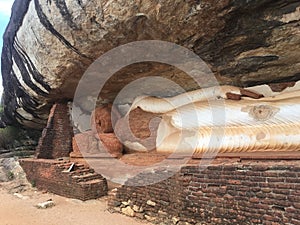 A stone sleeping moment statue of Lord Buddha Pindurangala