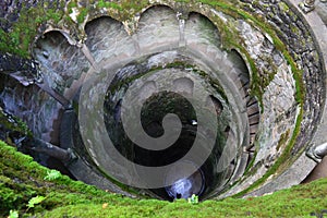 Stone spiral staircase in the form of a well. view from above