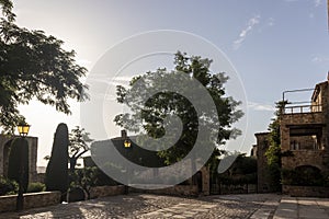square in the medieval village of pals on the bava coast on a summer day at sunset photo