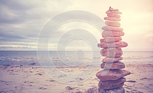 Stone stack pyramid on a beach, zen, harmony and balance concept, color toning applied