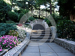 Stone stair in green tropical garden as part of hiking trail.