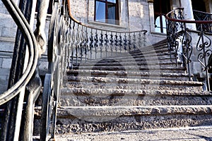 stone stair treads .stone staircase with iron railing and wooden handle.building entrance