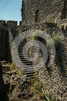 Stone staircase going up the wall with merlons and squared tower
