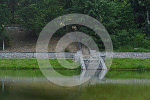 A stone staircase at Lake Stairs lead from a road in the lake below.