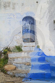 Stone staircase with old blue door