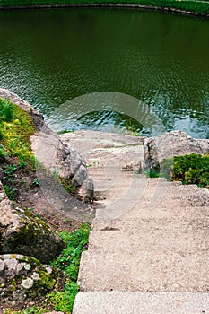 Stone staircase in the park with a descent to the water
