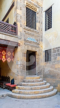 Stone staircase and wooden door leading to old Mamluk era Beit El Sennary building, Cairo, Egypt photo