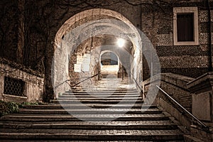 Stone stairs with arch in Rome, Italy. Small secret alley