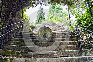 stone stairs with a fountain in the middle and covered with vegetation. Park of the brothers Naveira, betanzos, Galicia, Spain