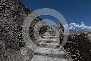 Stone stairs of Leh palace leading straight upwards.