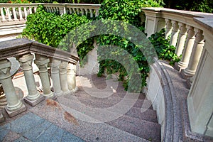 Stone stairs with marble steps go down.