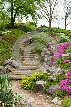 Stone stairs in the park surrounded by flowers