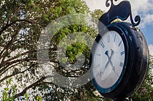 Old clock over the blue sky and white clouds