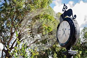 Old clock over the blue sky and white clouds