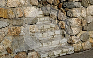 A stone stairway hidden in ancient stone wall