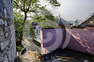 Stone stairway outside enclosed ancient temple in morning