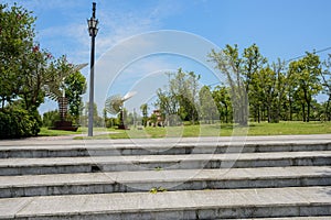 Stone stairway before wayside streetlamp in sunny summer afternoon