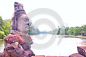 Stone statue of Asura at the south gate of Angkor Thom, Angkor Wat. Overlooking the Moat