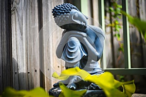 Stone statue of Buddha sitting and praying