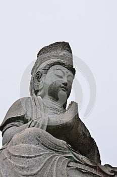Stone statue of Buddha at temple in Sagano district in Kyoto, Japan