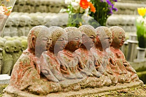 Stone statue of Buddhist monks sitting and praying