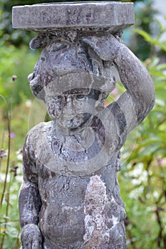 Stone statue of a child - Portmerion Village in Wales