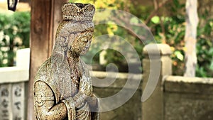 Stone statue guardian at Daikeiji temple in Tokyo