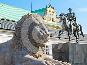 Stone statue of a lion and monument to Prince Jozef Poniatowski near Presidential Palace, Warsaw