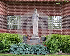 Stone statue of Reverend Charles Nerinckx on the campus of Nerinx Hall in Saint Louis, Missouri. photo