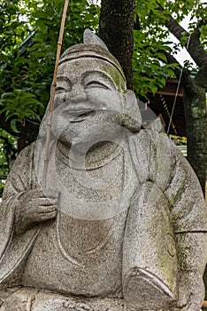 Stone statue in a Shintoist shrine in Tokyo photo