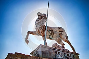 A stone statue of warrior in ruins of the city Pompei