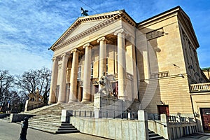 stone statues and classicist facade of an Opera building photo