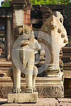 Stone statues guarding the ruins of the Hindu temple in the Phimai Historical Park in Nakhon Ratchasima, Thailand.