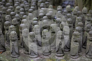 stone statues of Ksitigarbha bodhisattva (Jizo) at Hasedera Temple, Kamakura, Japan on a rainy day