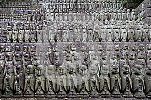 stone statues of Ksitigarbha bodhisattva (Jizo) at Hasedera Temple, Kamakura, Japan on a rainy day