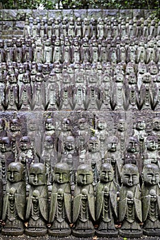 stone statues of Ksitigarbha bodhisattva (Jizo) at Hasedera Temple, Kamakura, Japan on a rainy day