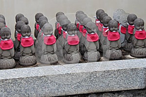 Stone statuettes of Buddhist divinities were placed in the courtyard of a temple (Japan)