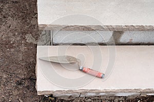 Stone step, closeup. Construction tool. Professional installation of a flight of stairs