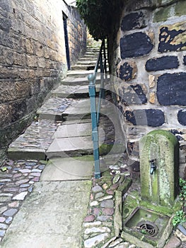 Stone steps in alley way with railing from seaside town uk