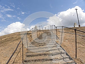 Stone steps with iron railings which leads to the top of mountain