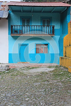 Stone street, colorful houses and ruins of the La Encarnacion foundry in Zimapan Hidalgo Mexico photo