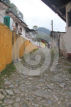 Stone street, colorful houses and ruins of the La Encarnacion foundry in Zimapan Hidalgo Mexico photo