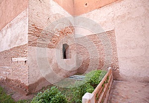 Stone and stucco building with fence and garden